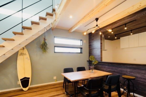 【当社施工例/ダイニング・キッチン】
キッチンスペースには天井も含め、全体的に濃い色目の天然の木材を使用して特別感のある仕上げに。サーフボードを置いても違和感のない、リゾート感あふれる雰囲気となっています。